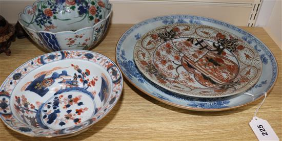An 18th century Chinese blue and white dish, 34cm and two Imari bowls and a dish, 19.5-27cm (4, all restored)